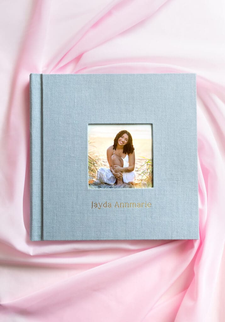 Custom senior photo album with linen cover and photo window designed by Petal and Stone Photography in Winter Garden, Florida.